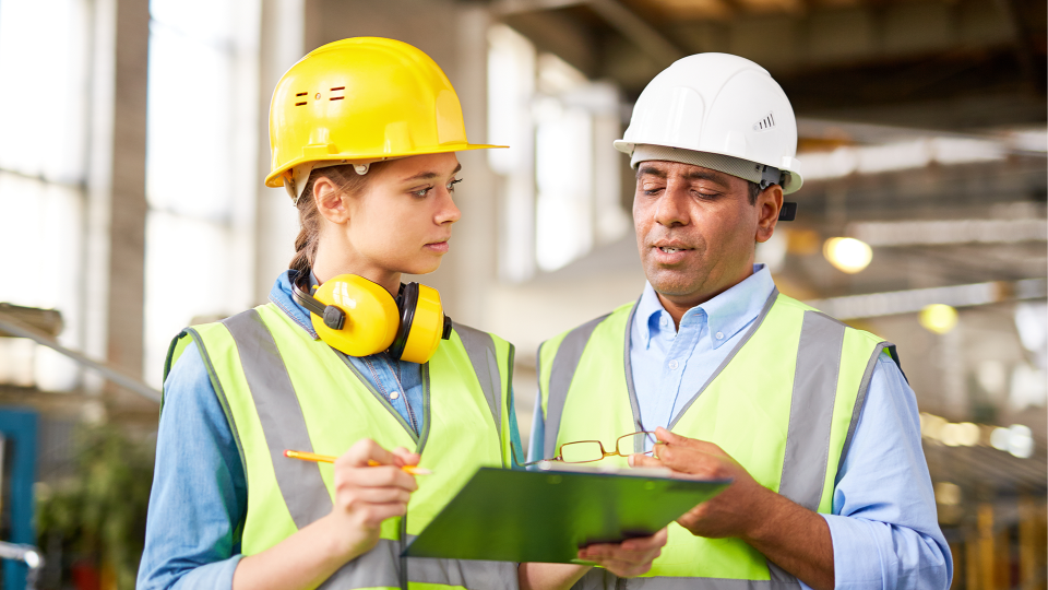 Two people looking at clipboard